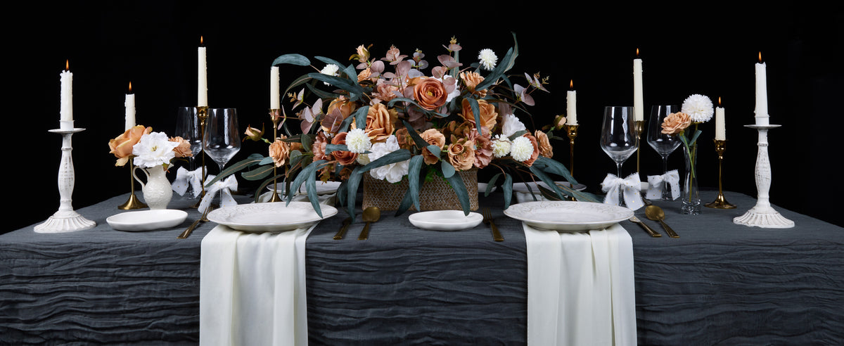 White gold-dot chiffon ribbon bows accent an elegant candlelit table with peach and white flowers.