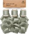 Dusty green silk satin ribbon on a wooden spool