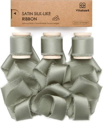 Dusty green silk satin ribbon on a wooden spool
