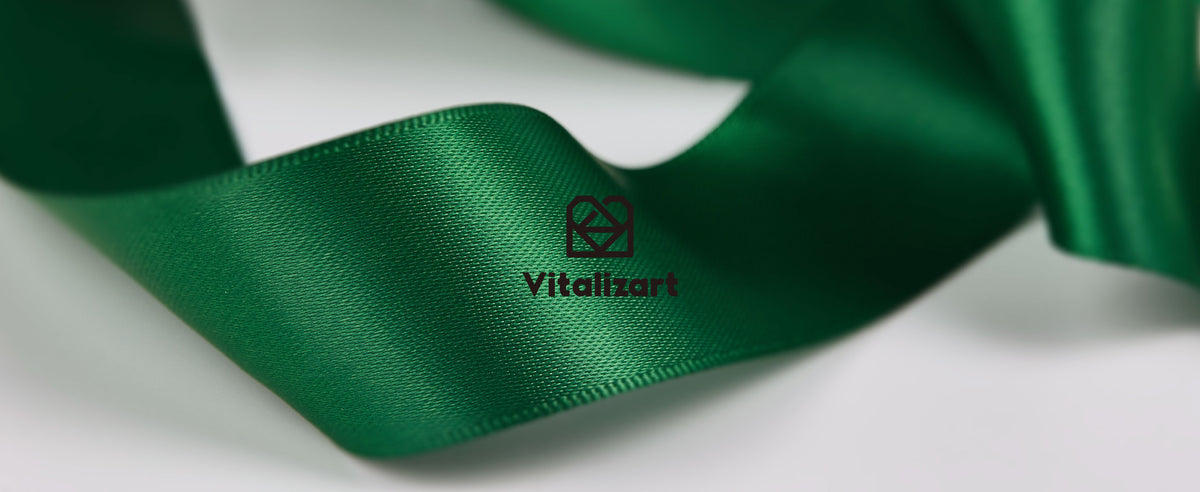 Glossy emerald-green satin ribbon in soft folds, showing its fine woven texture and finished edges.