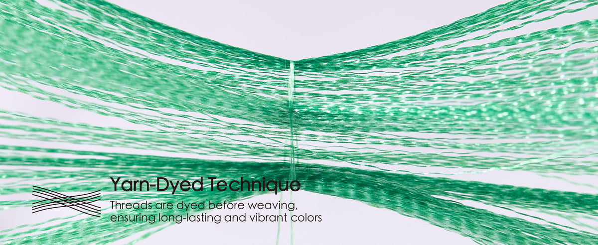 Separated green ribbon threads converge to illustrate the yarn-dyed weaving technique