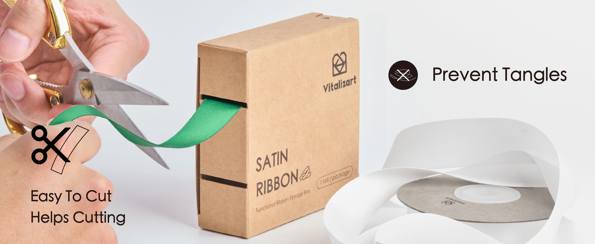 Green satin ribbon feeds from a cardboard dispenser while being cut with scissors