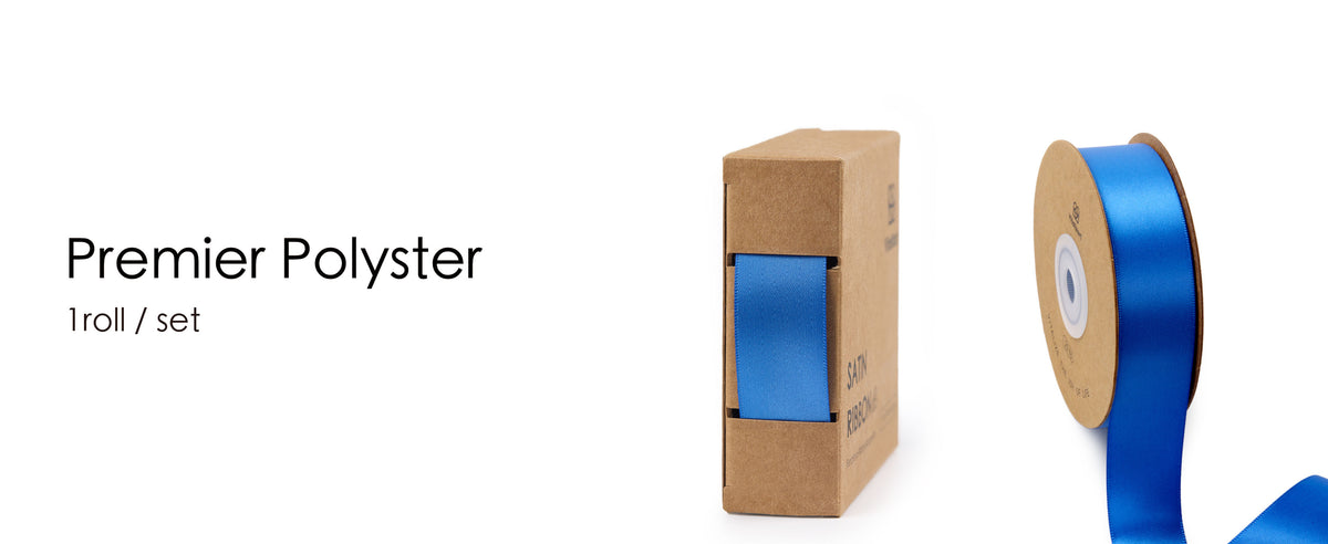 Blue satin ribbon on a kraft spool beside a matching cardboard dispenser box