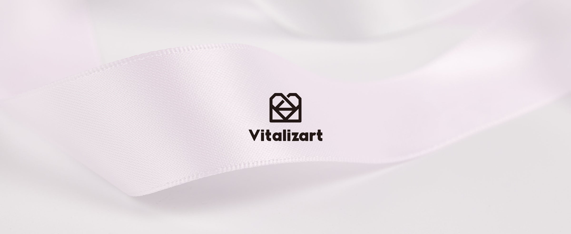 Close-up of pale pink satin ribbon with a subtle sheen, woven texture, and finished edge
