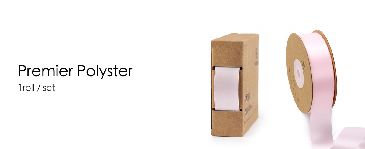 Light pink satin ribbon on a kraft spool beside a matching cardboard dispenser box