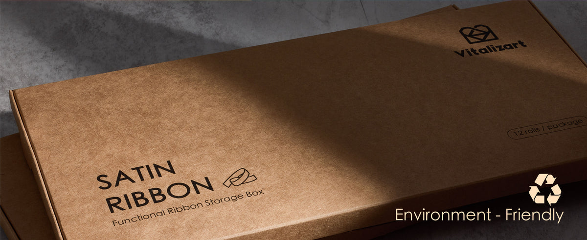 Two stacked cardboard satin ribbon storage boxes with Vitalizart branding and a recycling symbol