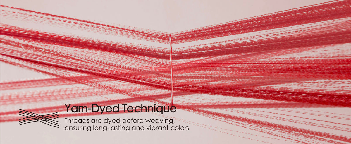 Red ribbon yarns spread apart to demonstrate the yarn-dyed construction before weaving