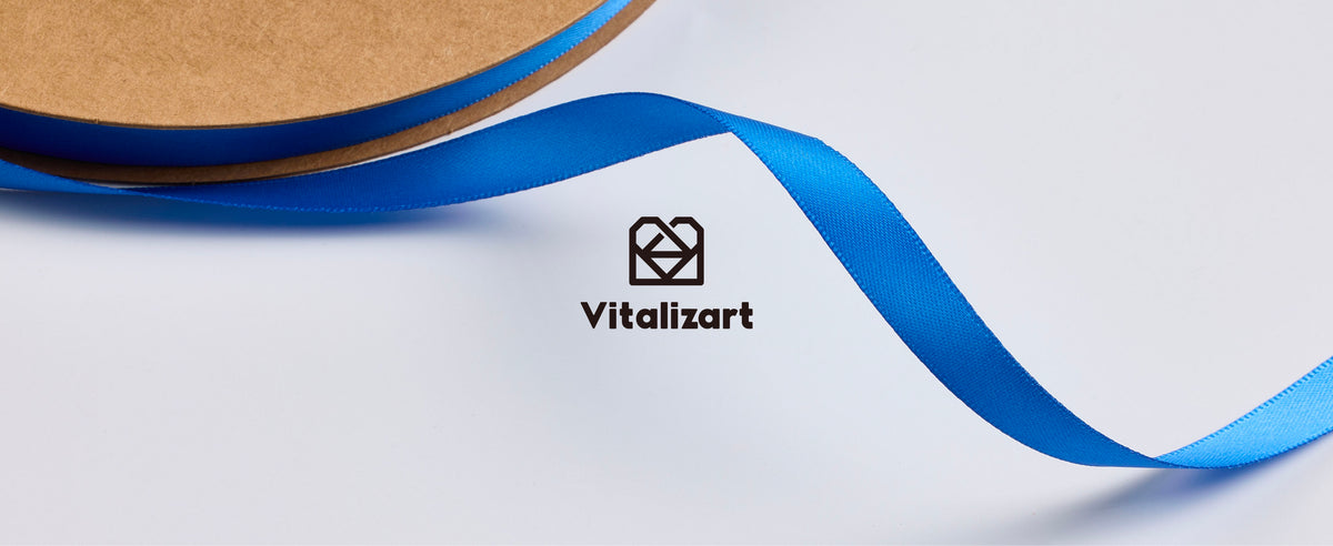 Blue satin ribbon decorates a bag, ponytail, gift box and floral arrangement above boxed rolls.