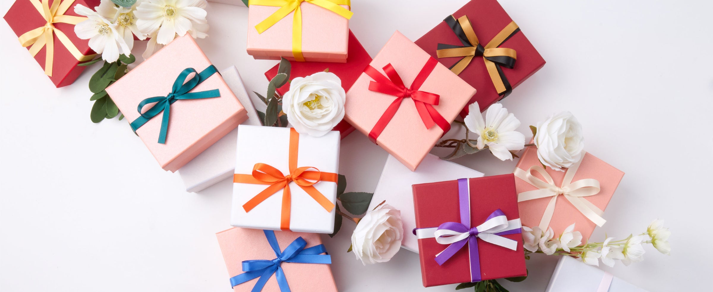 Wrapped gifts decorated with layered bows made from the rainbow double-faced satin ribbon set