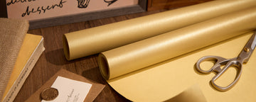Gold pearlescent wrapping paper rolls with scissors