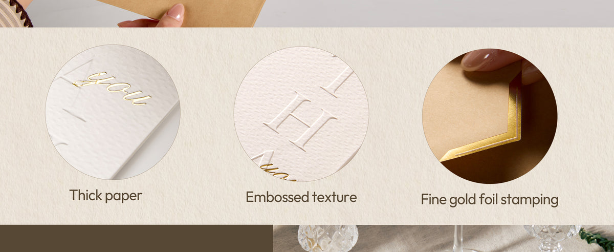 Close-up of white cards showing textured cardstock, embossed lettering, and gold foil