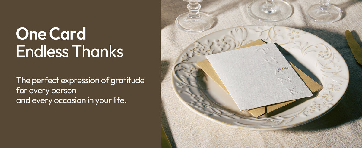 White embossed thank-you card used as a place card in an elegant table setting