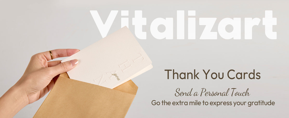White embossed thank-you cards and envelopes arranged as a refined stationery set on a neutral tabletop