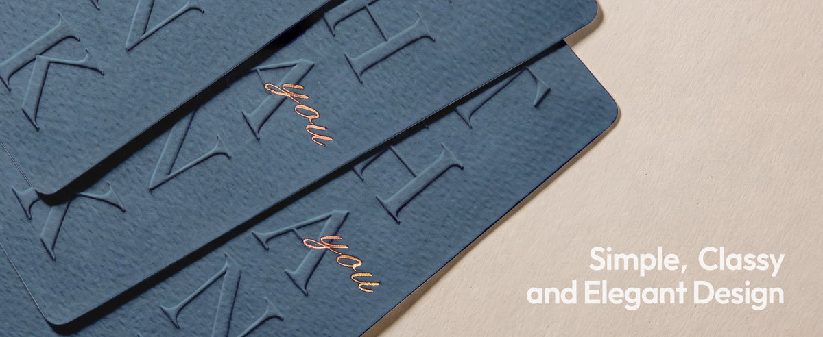 Dusty sage embossed thank-you cards and envelopes arranged as a coordinated stationery set on a neutral tabletop