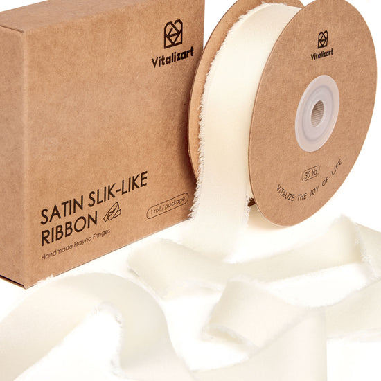 Ivory white frayed silk satin ribbon roll on a white background