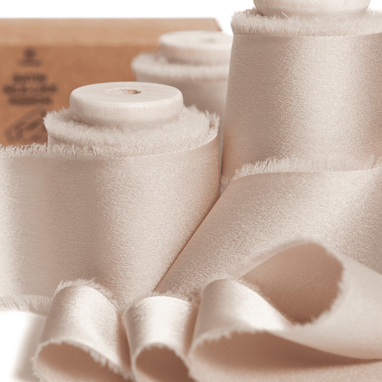 Light nude silk satin ribbon wound on a wooden spool