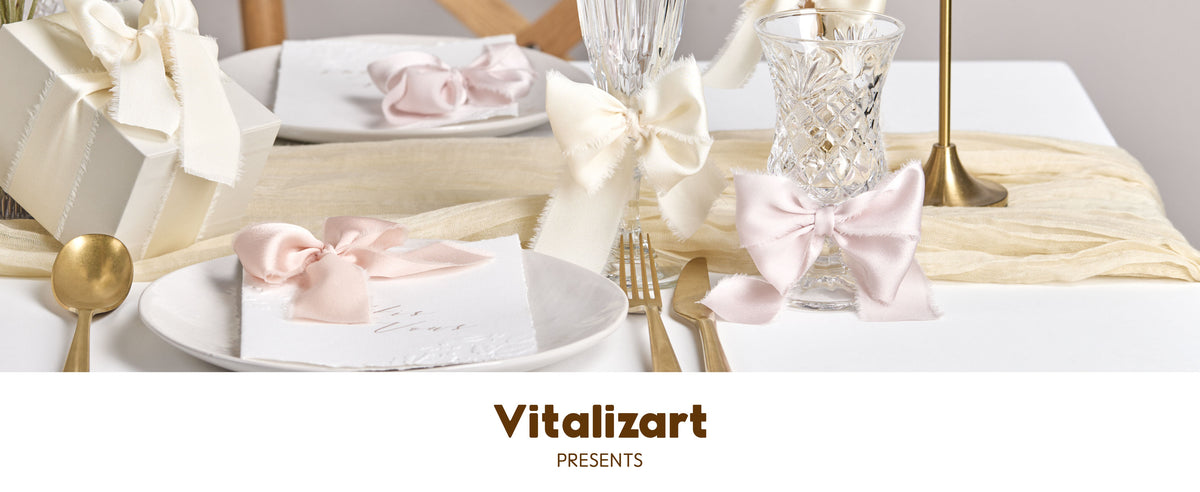 Ivory and pale pink frayed ribbon bows decorate gifts, glassware, place settings, and candleholders.
