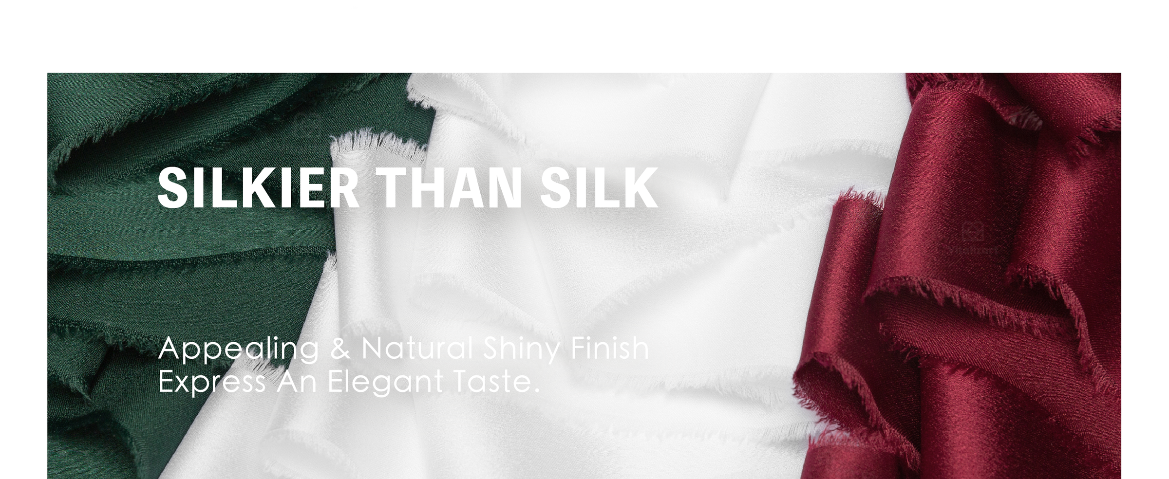 Burgundy frayed ribbon bows decorate a wrapped Christmas gift and a snowy evergreen wreath.