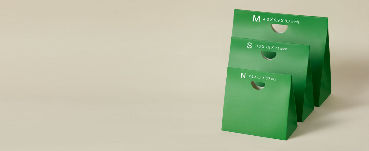 Three green paper gift bags compare mini, small, and medium sizes with printed dimensions.
