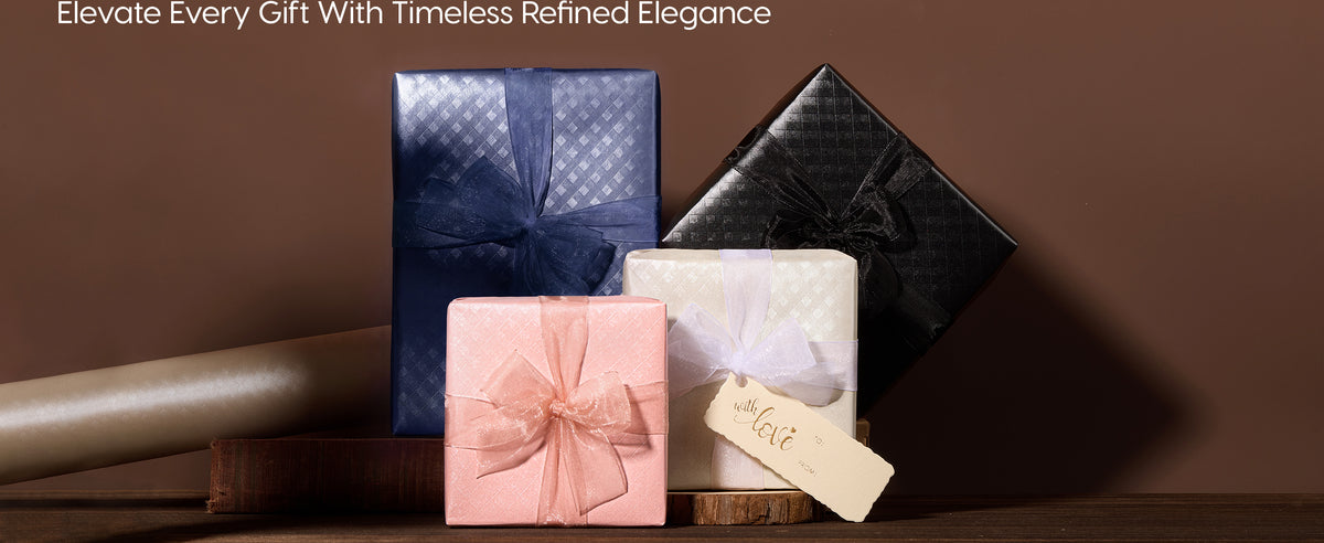 Four gifts in pearlescent grid wrapping paper with sheer bows in navy, black, pink, and ivory.