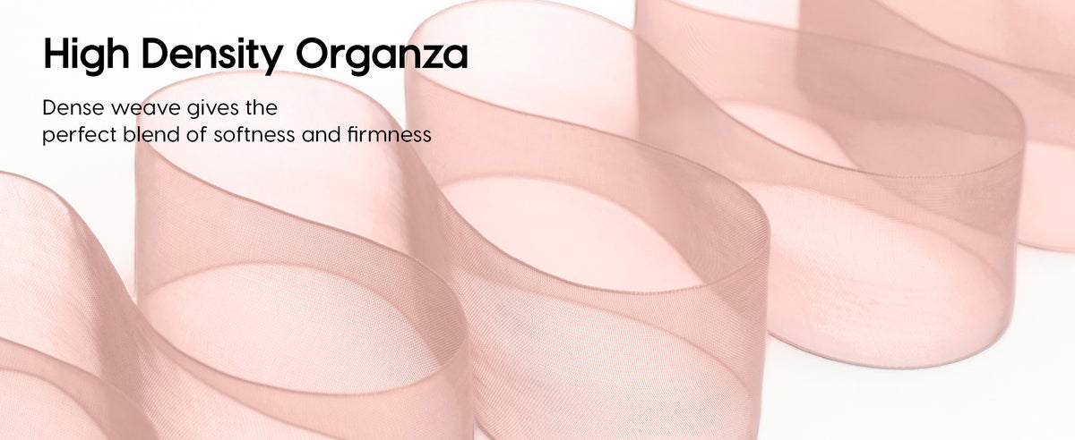 Blush-pink sheer organza ribbon arranged in loose waves, showing its dense weave and finished edges