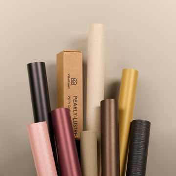 Pearlescent wrapping paper rolls in black, gold, rose and neutral colors