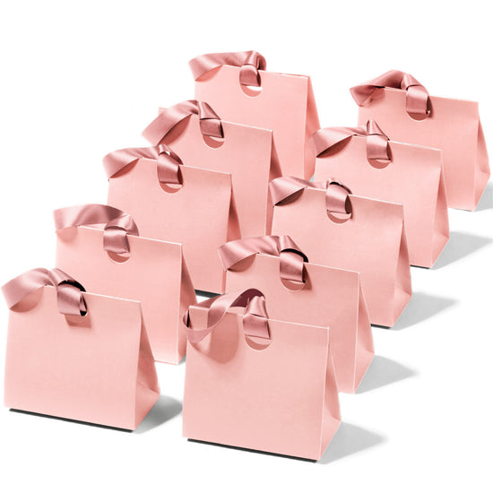 Mini pink paper gift bags with ribbon handles