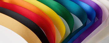 Close-up of satin ribbons arranged in rainbow colors