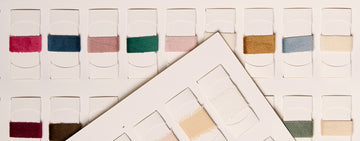 Ribbon sample book displaying assorted colors and fabrics
