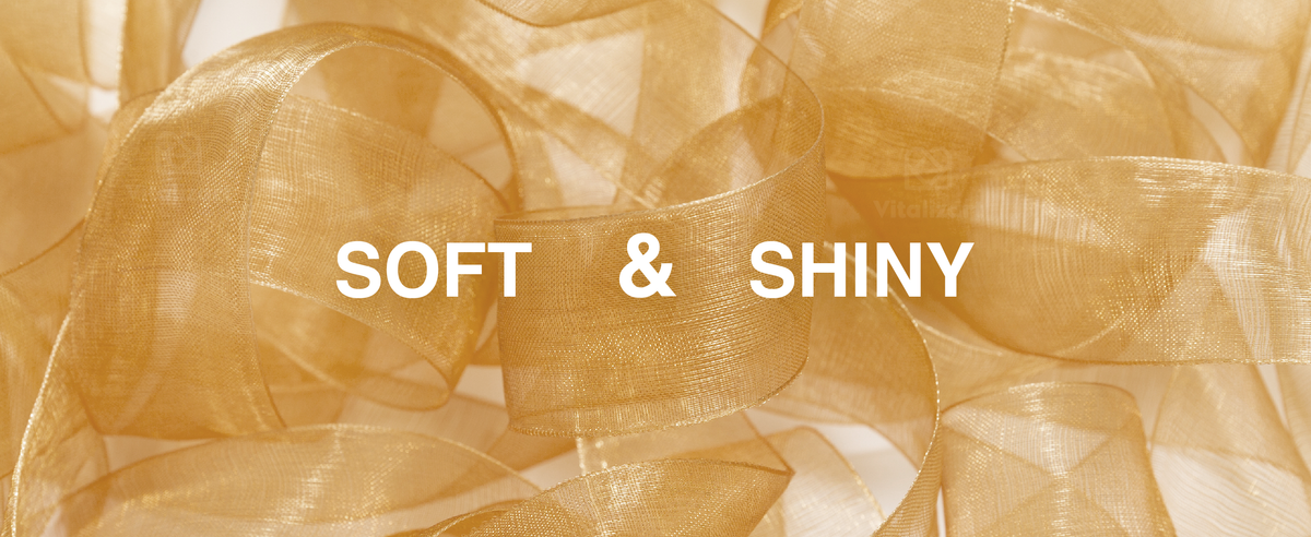 Translucent gold organza ribbon with a fine woven texture, arranged in soft, shimmering loops.