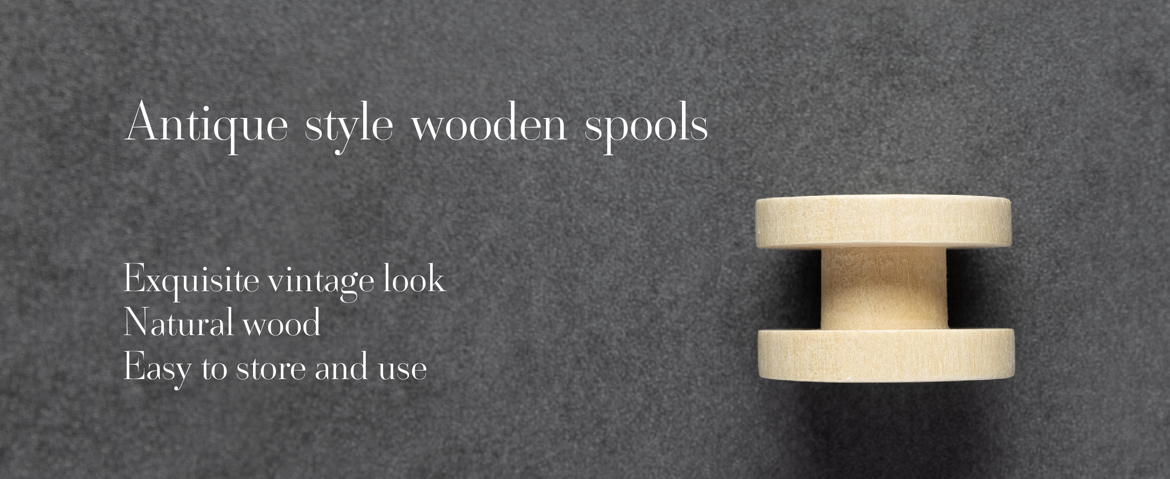 Natural wood ribbon spool with round flanges and visible grain on a dark gray textured surface.