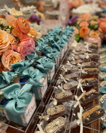 Teal ribbon bows decorating floral gift favors