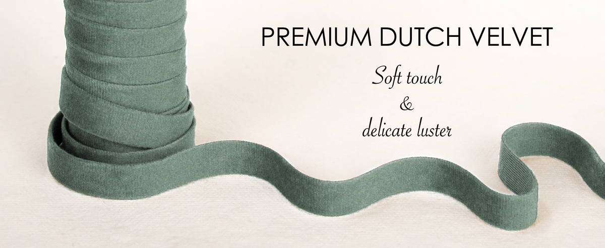 Close-up of layered dusty green Dutch velvet ribbon showing its soft pile and subtle luster.