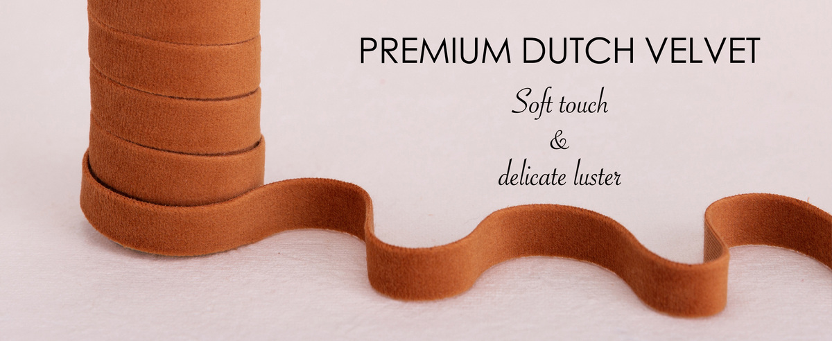 Close-up of layered terracotta velvet ribbon showing its soft pile and subtle luster.