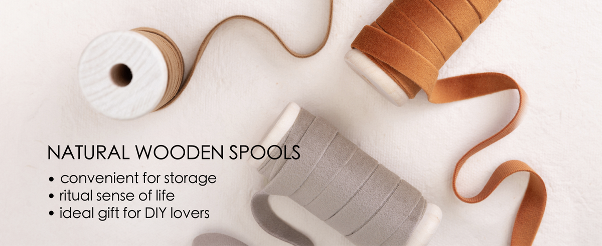 Velvet ribbon color assortment on wooden spools, including green, ivory, rose, brown, red, and navy.
