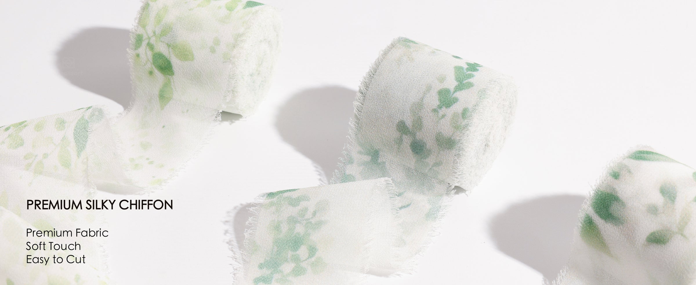 Green leaf-print frayed ribbon wraps a wax-sealed card and adorns a white flower basket