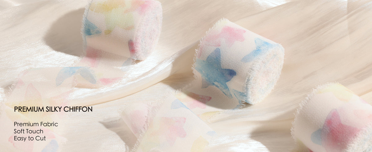 Pastel printed silky chiffon ribbon rolls with sheer fabric and soft frayed edges on cream satin