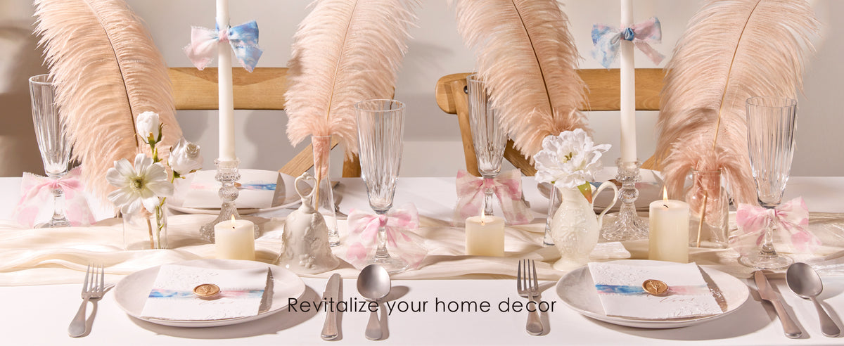 Pastel frayed chiffon ribbon bows accent candles and glassware on a blush feather dining table