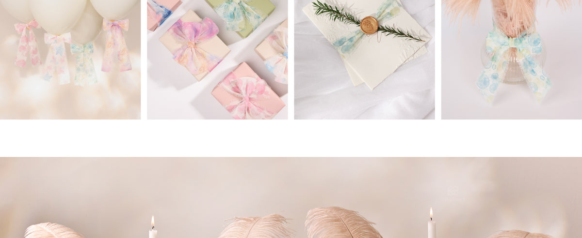 Pale blue-green printed frayed ribbon decorating a sealed envelope and feather-filled glass vase