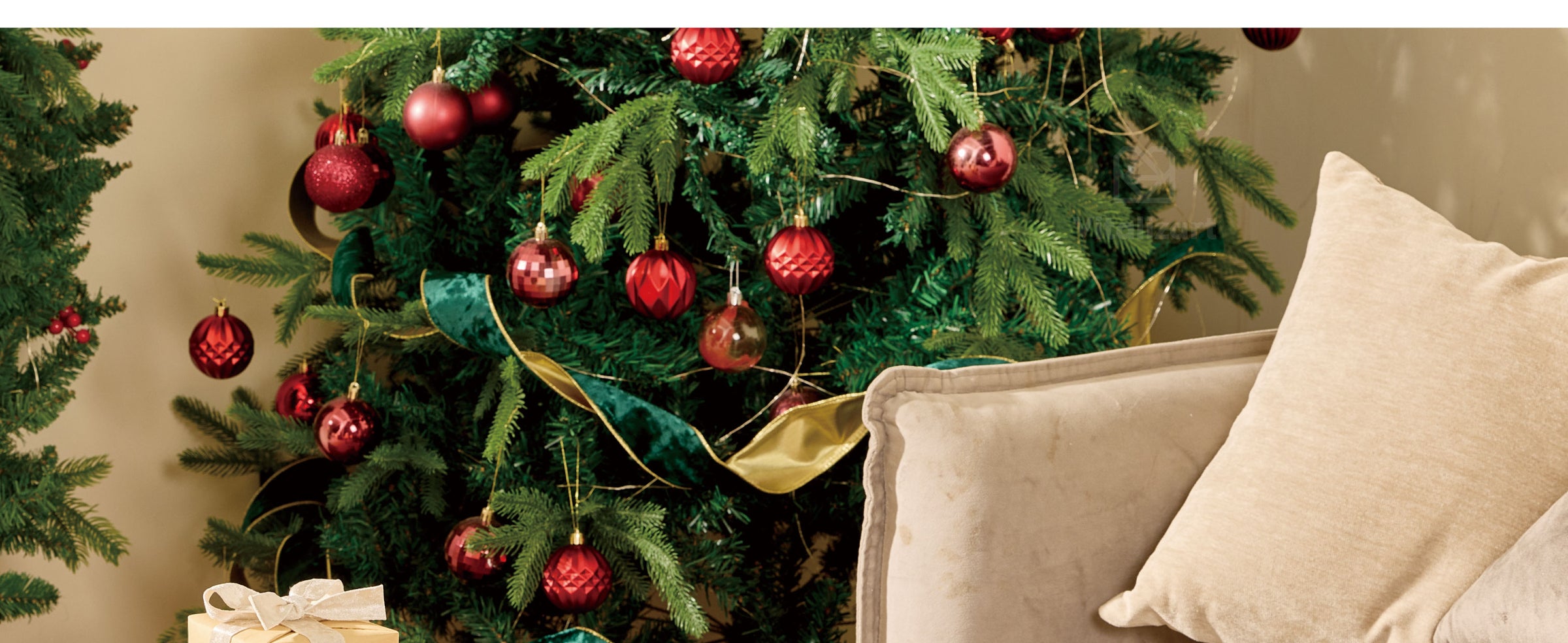 Metallic silver velvet bows decorating frosted greenery and a snowy Christmas wreath with red accents