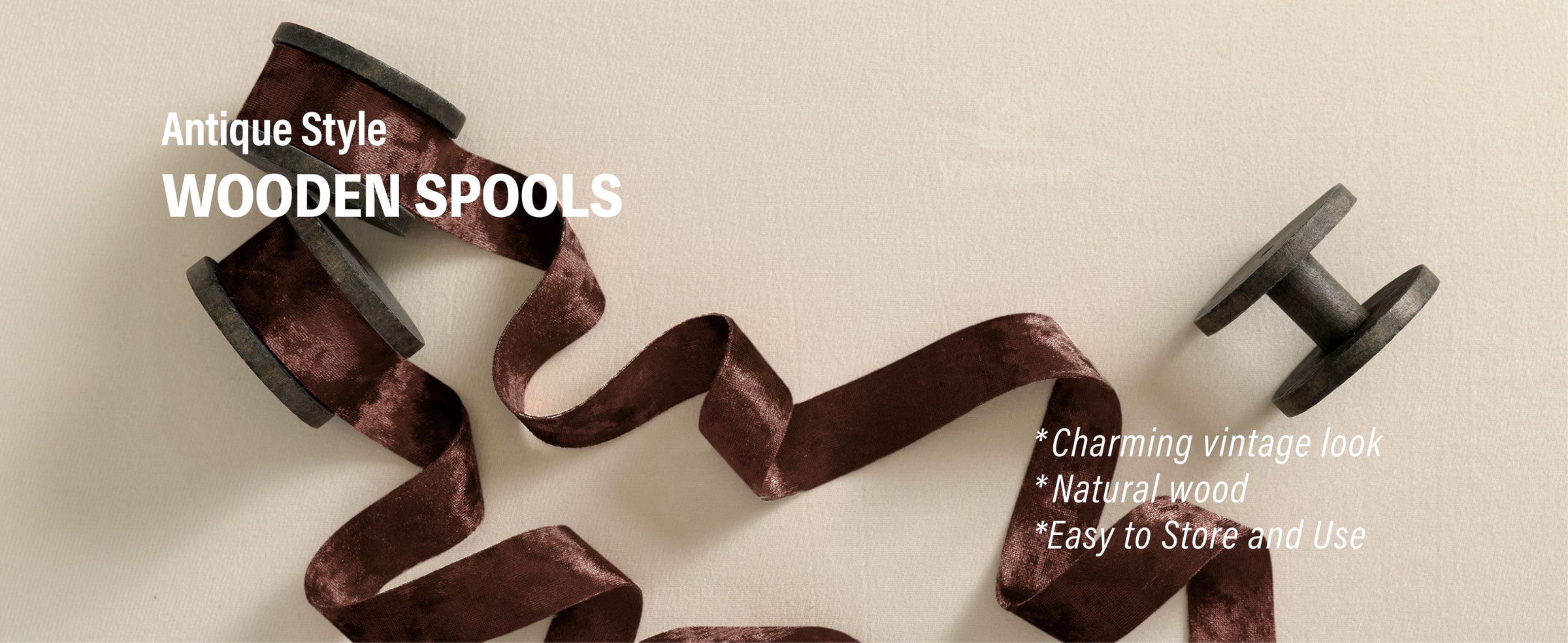 Dark brown crushed velvet ribbon unwound from antique-style natural wooden spools.