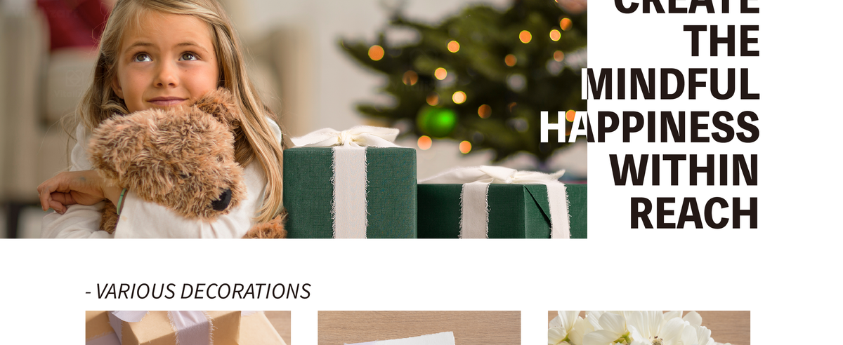 Young girl hugging a plush dog beside a green gift wrapped with pale fringed chiffon ribbon.