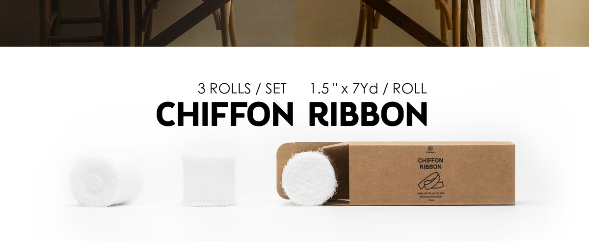 Three white chiffon ribbon rolls with fringed edges displayed beside an open kraft box.