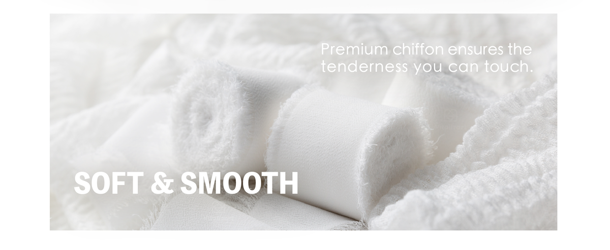 White chiffon ribbon rolls and loose lengths nestled in fabric, showing soft texture and fringed edges.