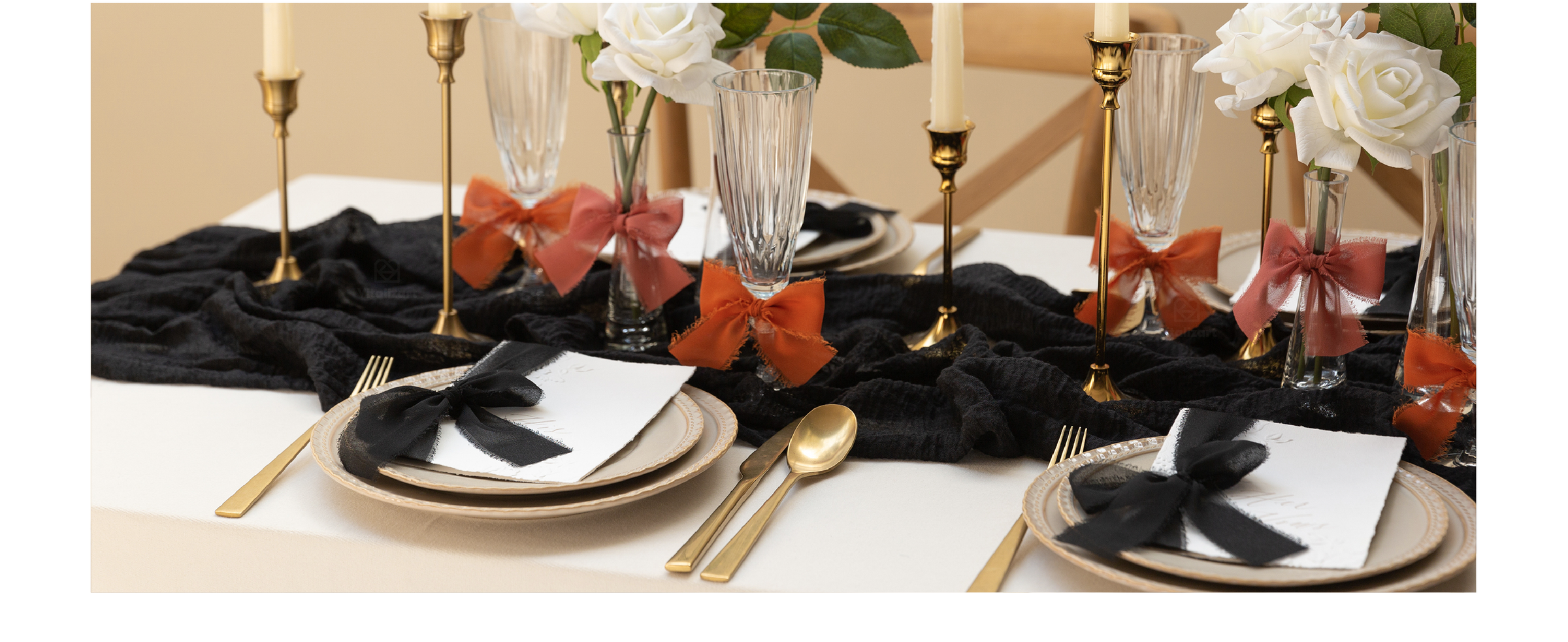 Blush and cream chiffon ribbon bows decorate glassware, cards, and flowers on a formal table