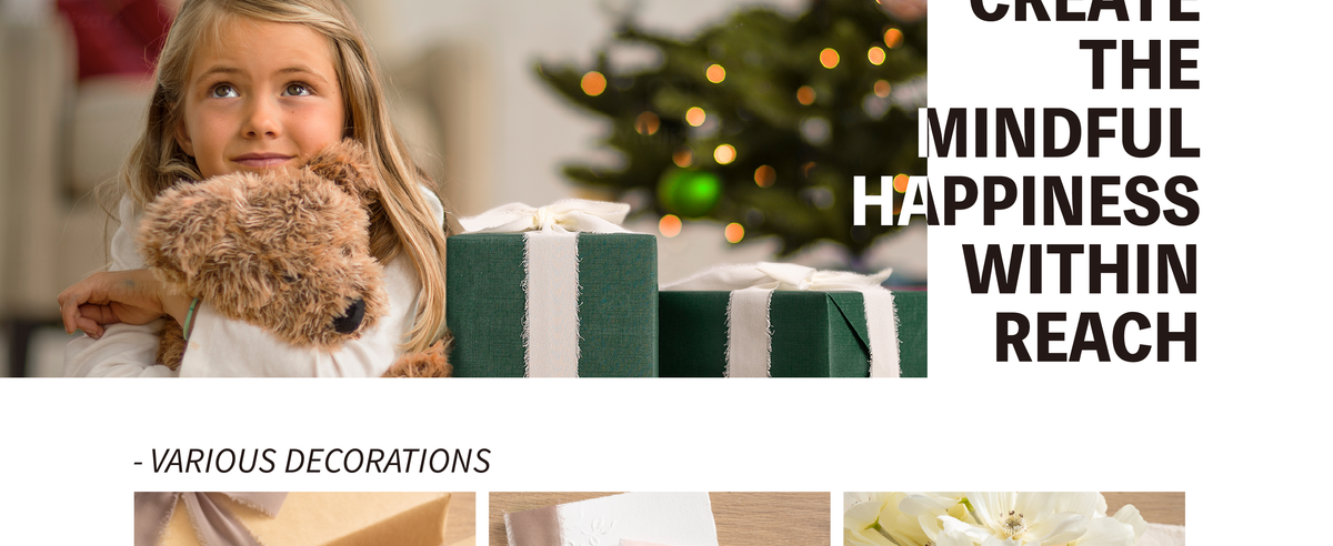Young girl hugs a plush dog beside a green gift wrapped with wide ivory fringed chiffon ribbon.