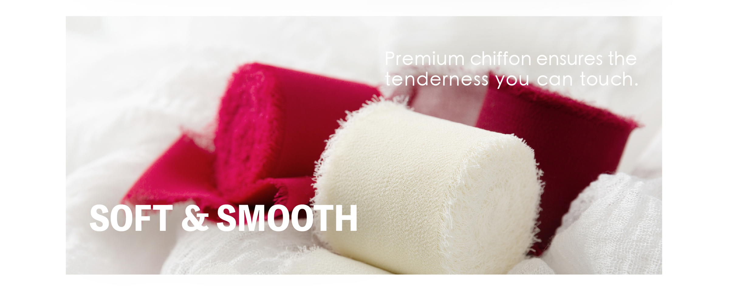 Soft burgundy and white chiffon ribbon rolls with feathery fringed edges on draped fabric.