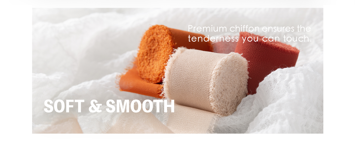 Cream, burnt orange, and rust fringed chiffon ribbon rolls arranged on soft white gauze.