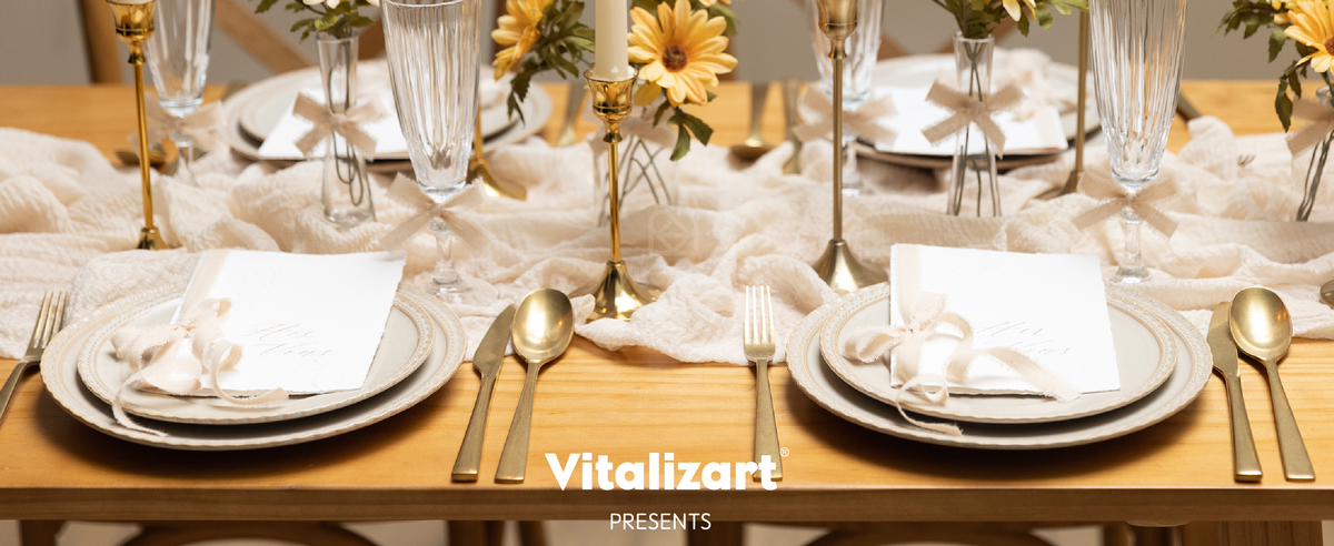 Light nude fringed ribbon bows decorate vases, glasses, and cards on a candlelit table