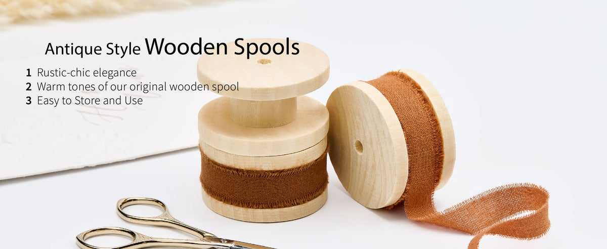Brown and rust fringed cotton ribbon on pale wooden spools with small gold-toned craft scissors.